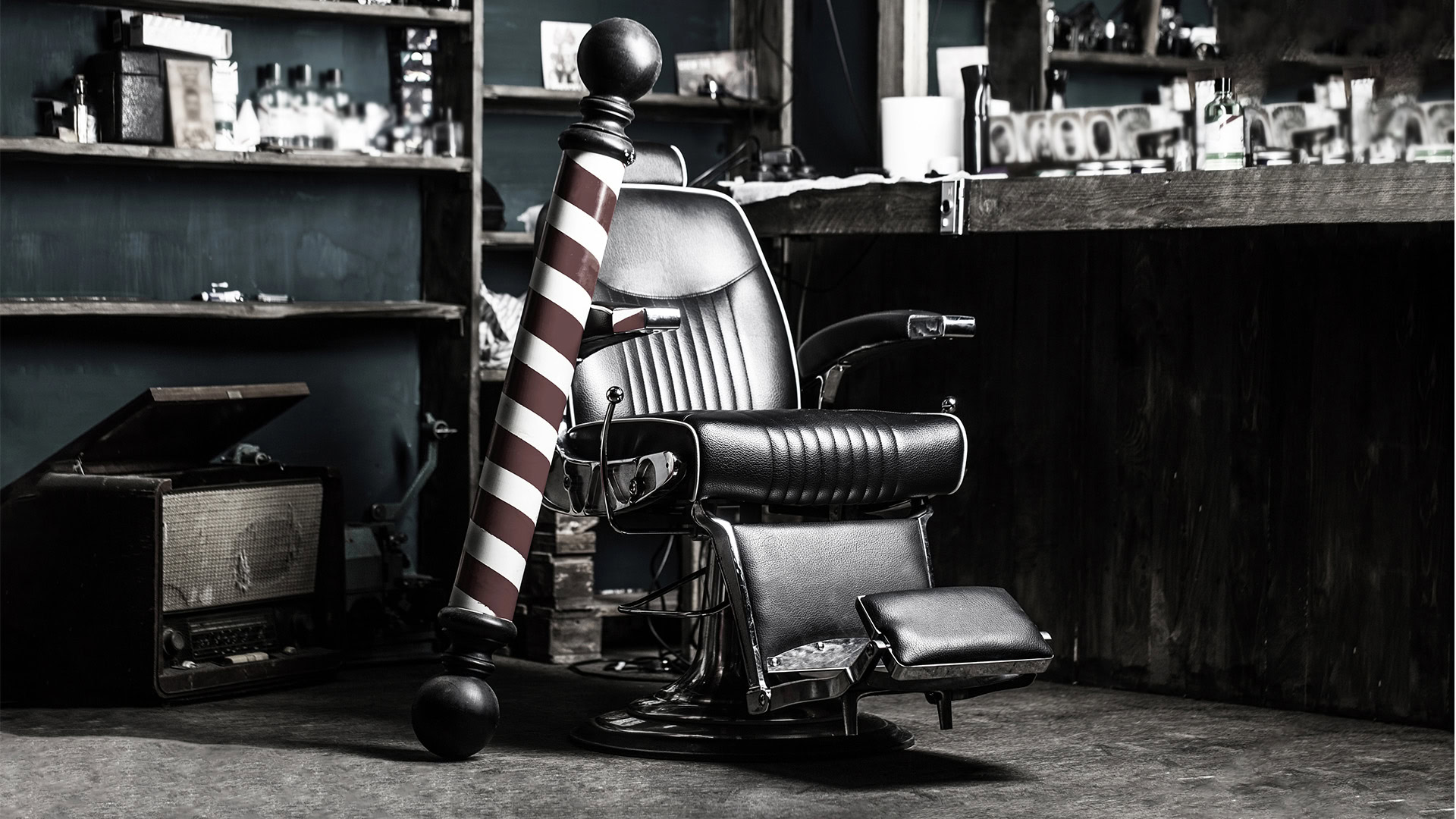 Classic barber chair with striped pole, vintage style, in a barbershop environment.